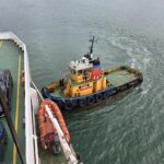 Red Funnel and tug